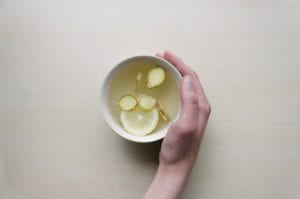Fresh sliced ginger and lemon brewed into a nausea-busting tea